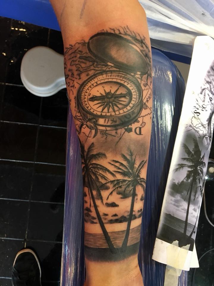palm trees and compass